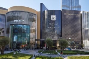 Graphic banner titled 'Dubai Mall Shopping Guide: Fashion Avenue' set against a chic marble and luxury retail background, KhaleejFusion