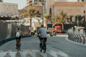 Graphic banner titled 'Outdoor Lifestyle in Dubai' featuring illustrations of beaches, hiking trails, and desert activities, KhaleejFusion