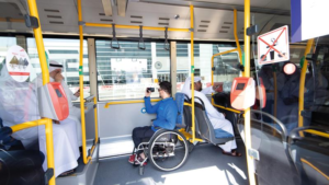 Interior of a Dubai public bus showing accessible seating and a dedicated wheelchair space, Khaleej Fusion